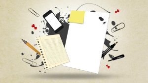 An ink blot against which a sheet of paper, a nee pad, post-its and an iPhone are arranged with other items of stationary exploding around it